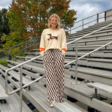 Cream lightweight long sleeved sweater with Weiner Dog graphic on front with orange stripes at the sleeves.