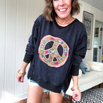 Washed charcoal pullover with exposed seams, a coral and floral peace patch on the front and split front hem.