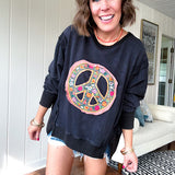 Washed charcoal pullover with exposed seams, a coral and floral peace patch on the front and split front hem.