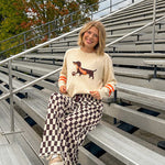 Cream lightweight long sleeved sweater with Weiner Dog graphic on front with orange stripes at the sleeves.