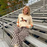 Cream lightweight long sleeved sweater with Weiner Dog graphic on front with orange stripes at the sleeves.