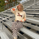 Cream lightweight long sleeved sweater with Weiner Dog graphic on front with orange stripes at the sleeves.