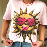 Bubble gum pink cotton tee with large orange sun with a face, pink sunglasses and bubble gum graphic.