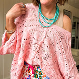 Soft, woven wide V neck sweater with 3/4 sleeves and a seashell design in the weave with exposed seams down the middle and at the shoulders. Oversized