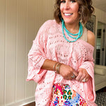 Soft, woven wide V neck sweater with 3/4 sleeves and a seashell design in the weave with exposed seams down the middle and at the shoulders. Oversized