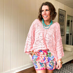 Silky athleisure material shorts with multi colored leopard print, pink drawstring and trim.