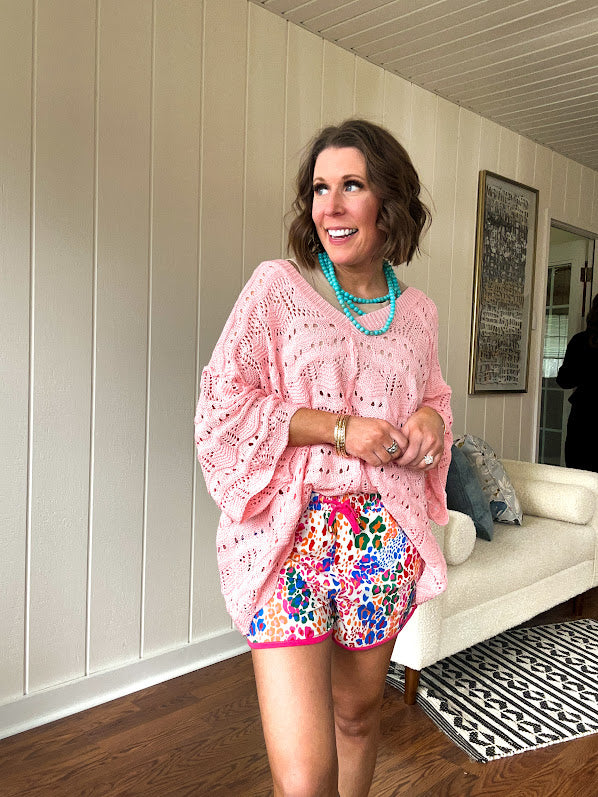 Soft, woven wide V neck sweater with 3/4 sleeves and a seashell design in the weave with exposed seams down the middle and at the shoulders. Oversized