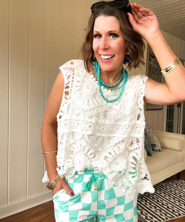Relaxed fit crochet tank with a sheer, open weave.
