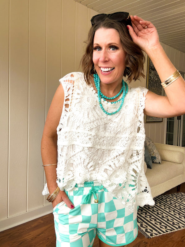 Relaxed fit crochet tank with a sheer, open weave.
