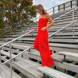 Red jumpsuit with white polka dots throughout, adjustable, removable spaghetti straps, wide leg design and cutout at the back.
