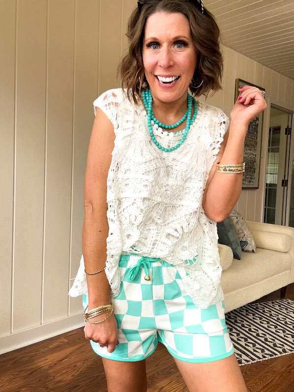 Relaxed fit crochet tank with a sheer, open weave.
