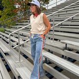 Light wash denim-like wide leg pants with leo and red striping down the sides and elastic, drawstring waist.