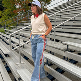 Light wash denim-like wide leg pants with leo and red striping down the sides and elastic, drawstring waist.
