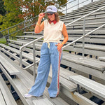 Light wash denim-like wide leg pants with leo and red striping down the sides and elastic, drawstring waist.