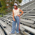 Light wash denim-like wide leg pants with leo and red striping down the sides and elastic, drawstring waist.