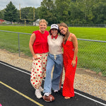 Light wash denim-like wide leg pants with leo and red striping down the sides and elastic, drawstring waist.