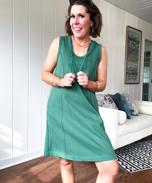 Terry-like forest green sleeveless hoodie dress with drawstring. Mini length.