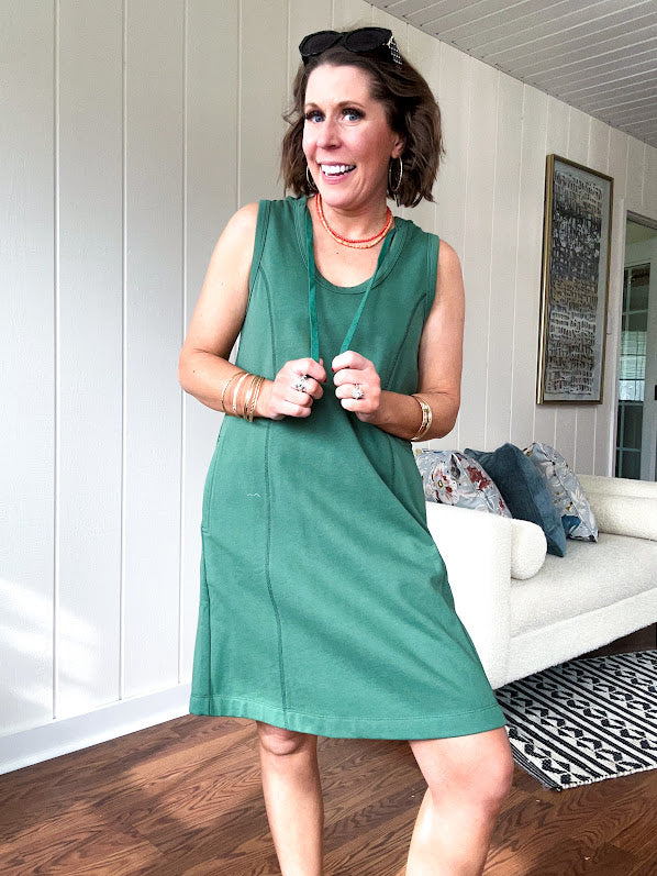 Terry-like forest green sleeveless hoodie dress with drawstring. Mini length.