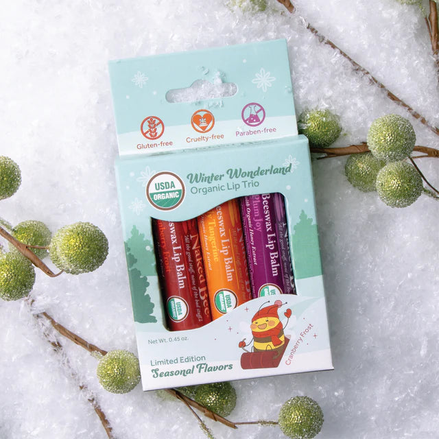 Box of three Naked Bee lip balms including Plum Joy, Jolly Tangerine and Cranberry Frost.