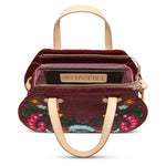 Plum Consuela bag with intricate floral embroidery, structured design, interior card slots, slide pocket, adjustable woven crossbody strap, or leather handles 