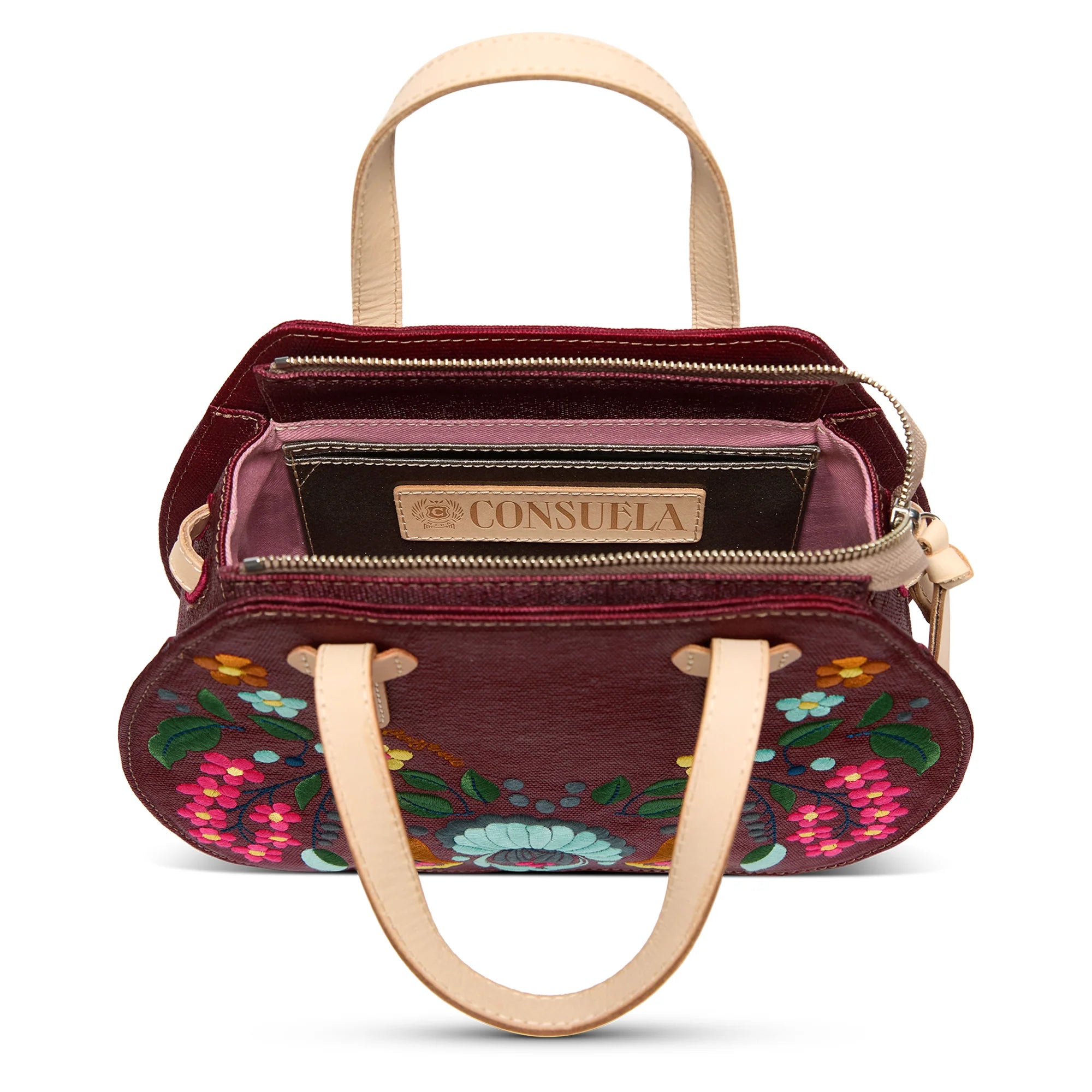 Plum Consuela bag with intricate floral embroidery, structured design, interior card slots, slide pocket, adjustable woven crossbody strap, or leather handles 