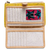 Consuela slim wallet in bright yellow with silver stars throughout and a white interior.