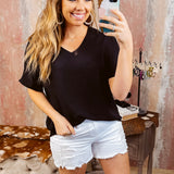 Lightweight and flowy black V neck dolman style short sleeved top.