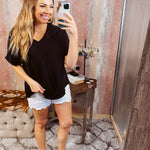 Lightweight and flowy black V neck dolman style short sleeved top.