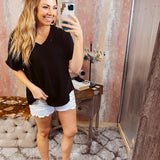 Lightweight and flowy black V neck dolman style short sleeved top.
